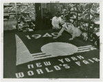 Flags - Man measuring letters on New York World's Fair flag