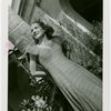 Florida Participation - Woman in evening dress leaning on palm tree