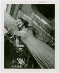 Florida Participation - Woman in evening dress leaning on palm tree