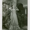 Florida Participation - Woman in evening dress leaning on palm tree