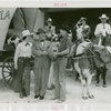 Florida Participation - Man who drove covered wagon from Florida presenting basket to Grover Whalen while Ruth Mix looks on