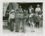 Florida Participation - Man who drove covered wagon from Florida presenting basket to Grover Whalen while Ruth Mix looks on
