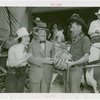 Florida Participation - Man who drove covered wagon from Florida presenting basket to Grover Whalen while Ruth Mix looks on