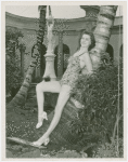 Florida Participation - Woman in bathing suit leaning on palm tree
