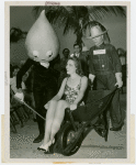 Florida Participation - Woman sitting in wheelchair pushed by Silas Sod as Pete Roleum oils the wheels