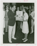 Florida Participation - Aviation Day - Grover Whalen receiving cigars from Miss Tampa