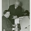 Ford - Ferde Grofé playing a Novachord while Dr. J. Francis Cooke looks on.