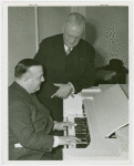Ford - Ferde Grofé playing a Novachord while Dr. J. Francis Cooke looks on.