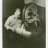 Ford - Exhibits - Cycle of Production - Man using band saw to cut figure of donkey
