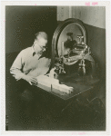 Ford - Exhibits - Cycle of Production - Man using band saw to cut figure of donkey