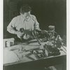 Ford - Exhibits - Cycle of Production - Man attaching leg to figure of donkey