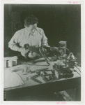 Ford - Exhibits - Cycle of Production - Man attaching leg to figure of donkey