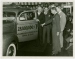 Ford - Ford, Edsel - Showing 28 millionth Ford car to A. Harry Moore, Santiago Suarez, Douglas S. Cole and crowd