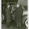 Ford - Ford, Edsel - Shaking hands with Harvey Gibson while James Rooney sits in 28 millionth Ford car