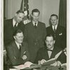 German Consul General, Johannes Borchers, signing contract with Grover Whalen while officials look on