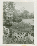 Gardens on Parade - Woman holding flowers on footbridge