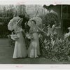 Gardens on Parade - Two women with parasols and baskets examining sculpture