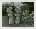 Gardens on Parade - Two women with parasols and baskets examining sculpture