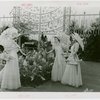 Gardens on Parade - Three women with parasols and baskets examining sculpture