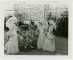 Gardens on Parade - Three women with parasols and baskets examining sculpture