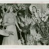 Gardens on Parade - Two women with parasols and baskets surrounded by flowers