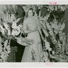 Gardens on Parade - Woman with parasol and basket surrounded by flowers