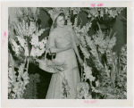 Gardens on Parade - Woman with parasol and basket surrounded by flowers