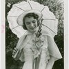 Gardens on Parade - Woman with parasol looking at flower