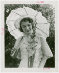 Gardens on Parade - Woman with parasol looking at flower