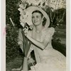 Gardens on Parade - Woman in hat looking at flower