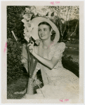 Gardens on Parade - Woman in hat looking at flower