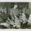 Gardens on Parade - Woman in hat surrounded by flowers