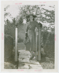 Gardens on Parade - Woman in hat standing at gate
