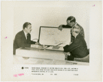 General Electric - Grover Whalen and Owen D. Young looking at map showing coverage of shortwave radio