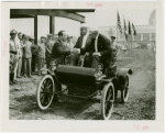 General Motors - William S. Knudson in car shaking hands with man