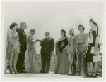 General Motors - Miss Futurama presenting model 1960s car to Harvey Gibson while other employees watch