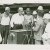 General Motors - Knudsen, William S. - With workers next to magnetic stove