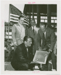 Glass Center - Grover Whalen and glass officials with glass block for cornerstone