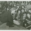 Glass Center - Jacqueline Cochran showing children fragment from America's first glass factory