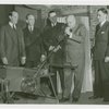 Glass Center - Glassblowing - Harvey Gibson blowing glass while officials watch