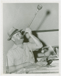 Glass Center - Glassblowing - Man with cigar blowing colored glass