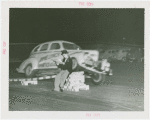 Goodrich Participation - Car going over ramp while Jo-Jo the Clown sits and reads paper