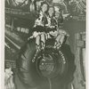 Goodrich Participation - Two women in cowgirl costumes sitting on tire