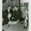 Great Britain Participation - Official signing guestbook while Grover Whalen watches