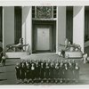 Great Britain Participation - Group of women with Trylon and Perisphere hats in front of exhibit