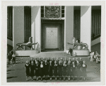 Great Britain Participation - Group of women with Trylon and Perisphere hats in front of exhibit
