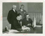 Greece Participation - Grover Whalen signing contract with Nicholas Tserepis (Consul General) and others