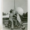 Nels Holmes on scooter with monkey