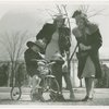 Billy Hertzke on tricycle with two women