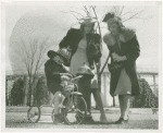 Billy Hertzke on tricycle with two women